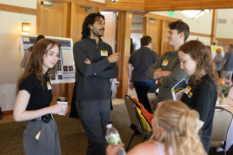 Students talking in front of poster session