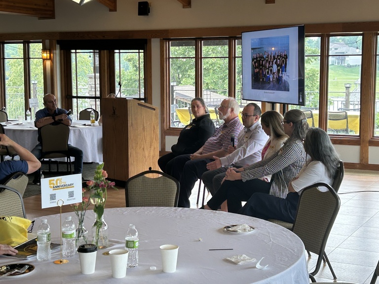 6 Alumni sitting in chairs for the alumni panel discussion