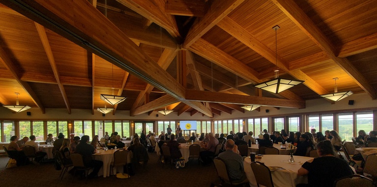 Photo of Brown Deer Banquet hall with tables full of students, faculty, and alumni