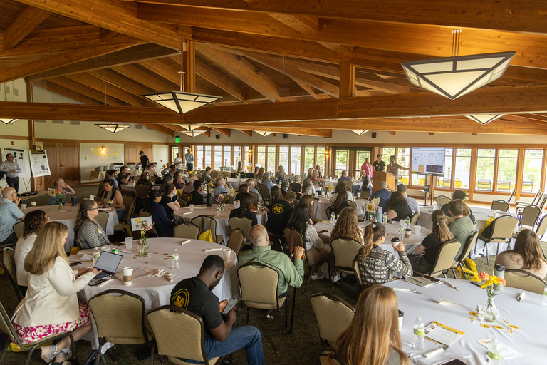 Students presenting 60 second pitches of their research posters