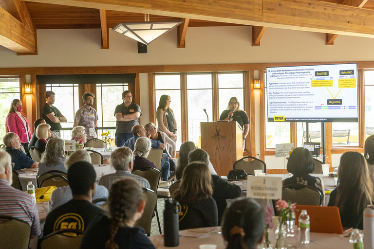 Students presenting 60 second pitches of their research posters